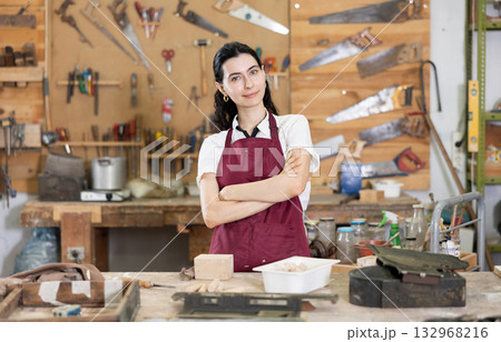 Young girl posing in taller workshop Young girl posing in taller workshop 132968216