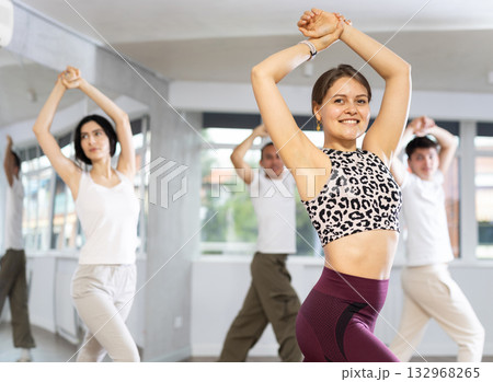Team of dancers performing contemporary dance in choreography studio 132968265