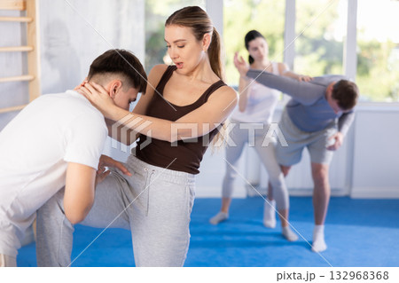 Self defense lesson - woman learns to fight back an attacking man 132968368