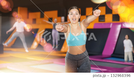 Young woman posing on workout in trampoline center 132968396