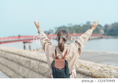 Woman tourist sightseeing Fukuura jima bridge or the bridge of romantic encounters for Fukuura Island at Matsushima Bay in Matsushima, Miyagi Prefecture, Tohoku, Japan. Landmark and famous Vacation 132970949