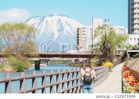 Woman tourist sightseeing Iwate mountain and Kitakami river with flowers in Spring, happy traveler travel in Morioka city, Iwate prefecture, Japan. famous Landmark Travel and Vacation destination Woman tourist sightseeing Iwate mountain and Kitakami river with flowers in Spring, happy traveler travel in Morioka city, Iwate prefecture, Japan. famous Landmark Travel and Vacation destination 132971004