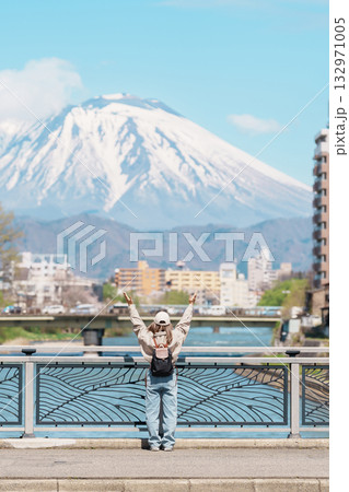 Woman tourist sightseeing Iwate mountain and Kitakami river with flowers in Spring, happy traveler travel in Morioka city, Iwate prefecture, Japan. famous Landmark Travel and Vacation destination Woman tourist sightseeing Iwate mountain and Kitakami river with flowers in Spring, happy traveler travel in Morioka city, Iwate prefecture, Japan. famous Landmark Travel and Vacation destination 132971005