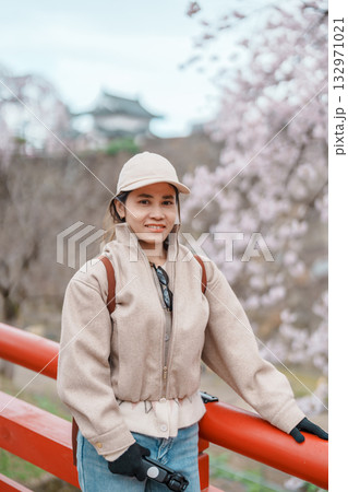 Woman tourist sightseeing Hirosaki Castle with Sakura Cherry Blossom in Spring, happy traveler travel in Hirosaki city, Aomori, Tohoku, Japan. Landmark famous in Japan. Travel and Vacation destination 132971021