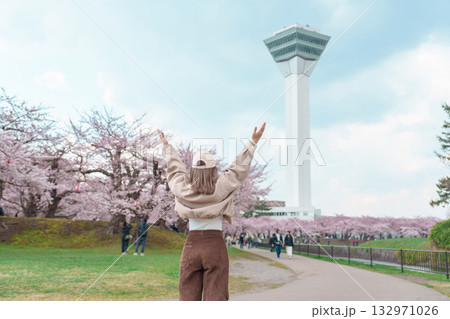 Woman tourist sightseeing Goryokaku Tower park with Sakura Cherry Blossom in Spring, happy traveler travel in Hakodate city, Hokkaido, Japan. famous Landmark, Japan Travel and Vacation destination 132971026