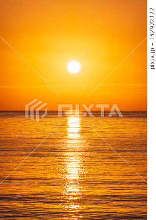 Beautiful red and orange sunrise over the sea. Beautiful red and orange sunrise over the sea. 132972122