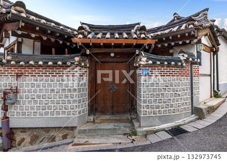 Traditional wooden door and entrance facade of a Hanok house within Bukchon Hanok Village, a famous cultural travel landmark Traditional wooden door and entrance facade of a Hanok house within Bukchon Hanok Village, a famous cultural travel landmark 132973745