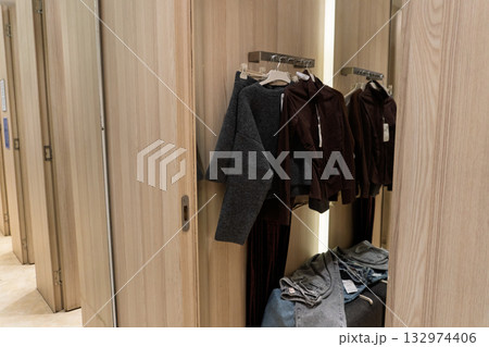 Clothes in a Fitting Room with Wooden Doors 132974406