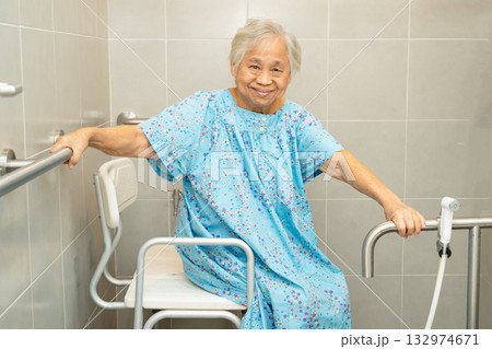 Asian elderly woman patient use toilet bathroom handle security in nursing hospital, healthy strong medical concept. 132974671