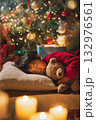Child sleeping by christmas tree with teddy bear and candlelight 132976561