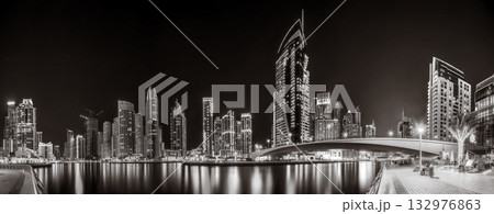 Skyscrapers and bridge over water, black and white style, city background, Dubai Marina bay UAE Skyscrapers and bridge over water, black and white style, city background, Dubai Marina bay UAE 132976863
