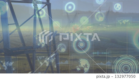 Featuring oil pump jack standing on grassy plain, projecting charts and map panels, copy space 132977050