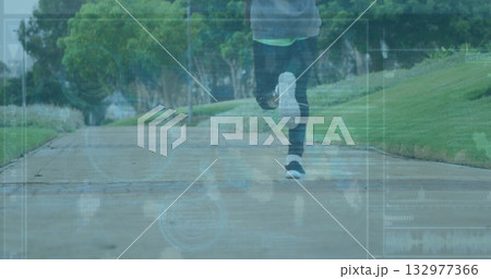 Running male wearing leggings and sneakers on concrete park path with grass banks and HUD data 132977366