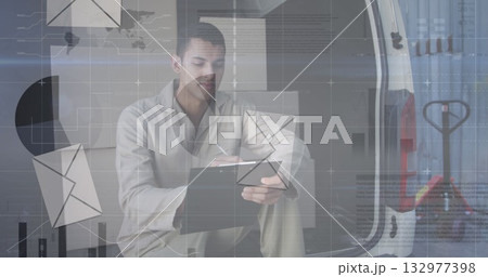 Holding clipboard and pen, delivery worker crouching inside cargo van, with digital overlay icons Holding clipboard and pen, delivery worker crouching inside cargo van, with digital overlay icons 132977398