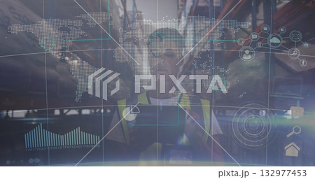 Worker wearing safety vest scanning racks with tablet in warehouse aisle with holographic overlay 132977453