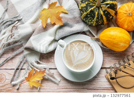 Autumn decoration with coffee cup, pumpkins, and a warm blanket 132977561