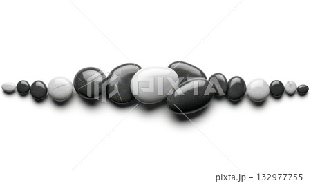 Row of black and white zen stones on white background for concept of balance, harmony, meditation, or spa 132977755