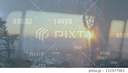 Projecting digital network globe across skyline with pine tree through window, with dreamcatcher 132977961