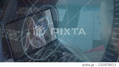 Man hosting meeting on laptop at desk, with gesturing woman on screen and floating data graphics Man hosting meeting on laptop at desk, with gesturing woman on screen and floating data graphics 132978013