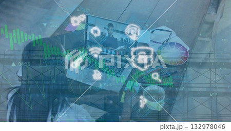 Displaying laptop showing call with colleague holding documents in home office with color palette 132978046