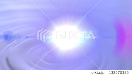 Emitting white light flare centered over rippled water surface in studio with lens flare halos Emitting white light flare centered over rippled water surface in studio with lens flare halos 132978326