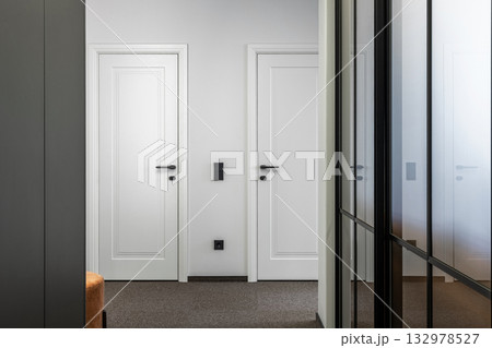 Minimalist Hallway with Two White Doors and Glass Partition 132978527