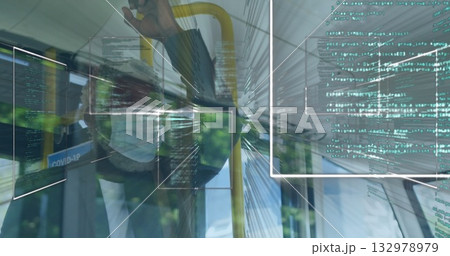 Standing male commuter gripping yellow handrail in bus, with Covid-19 poster and code panels 132978979