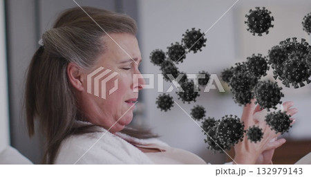 Holding hands out, woman wearing white robe on bed in bedroom, floating virus graphics, copy space 132979143