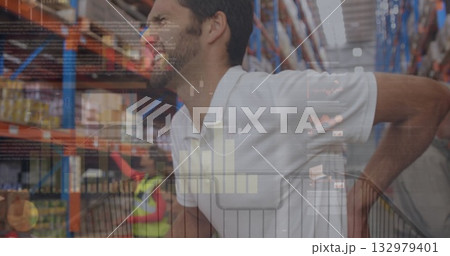 Leaning man shopper viewing digital data charts over store shelves in aisle, with cart and goods 132979401