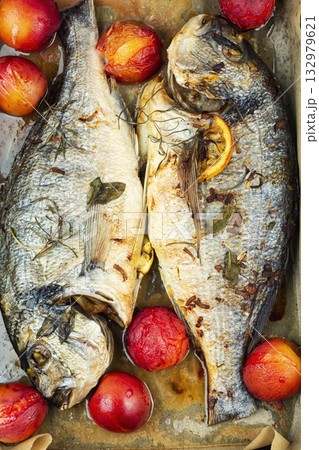 Grilled dorado fish with plums in baking sheet. Grilled dorado fish with plums in baking sheet. 132979621