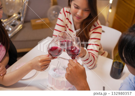 Group of Friends Celebrating Birthday Party with Cake and Gifts 132980357