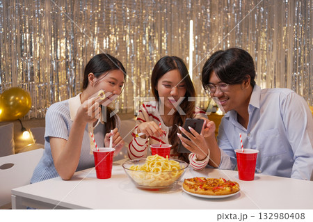 Group of Friends Celebrating Birthday Party with Cake and Gifts 132980408