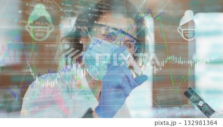 Lab scientist wearing PPE observing microscope sample at lab bench with data charts and figures Lab scientist wearing PPE observing microscope sample at lab bench with data charts and figures 132981364