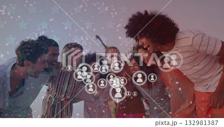 Laughing friends leaning together at beach park dusk, with floating social network icons 132981387