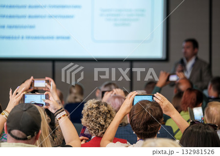 Conference audience records presentation with mobile phones during speaker session Conference audience records presentation with mobile phones during speaker session 132981526