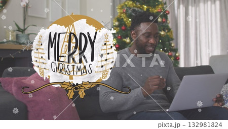Typing on laptop, man in sweater on sofa in living room, with Christmas overlay, copy space Typing on laptop, man in sweater on sofa in living room, with Christmas overlay, copy space 132981824