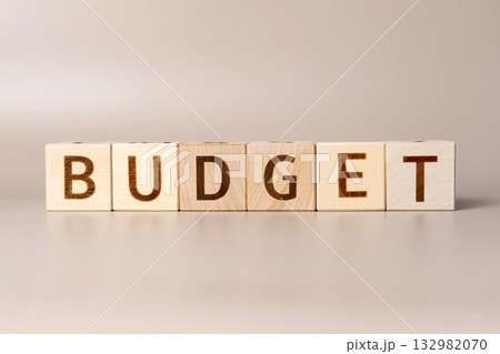 The word BUDGET on wooden cubes on a beige neutral studio background. Copy Space. Written. Text words matter. Conceptual Photo. Budget planning symbol. Write idea success solution concept. The word BUDGET on wooden cubes on a beige neutral studio background. Copy Space. Written. Text words matter. Conceptual Photo. Budget planning symbol. Write idea success solution concept. 132982070