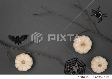Halloween black background with bats, spiders, pumpkins and twigs. Modern Holiday design. Halloween party border on Dark Gray colour. Flat lay, top view, copy space. Thanksgiving fall decoration. 2022 Halloween black background with bats, spiders, pumpkins and twigs. Modern Holiday design. Halloween party border on Dark Gray colour. Flat lay, top view, copy space. Thanksgiving fall decoration. 2022 132982356