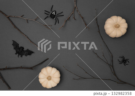 Halloween black background with bats, spiders, pumpkins and twigs. Modern Holiday design. Halloween party border on Dark Gray colour. Flat lay, top view, copy space. Thanksgiving fall decoration. 2022 Halloween black background with bats, spiders, pumpkins and twigs. Modern Holiday design. Halloween party border on Dark Gray colour. Flat lay, top view, copy space. Thanksgiving fall decoration. 2022 132982358