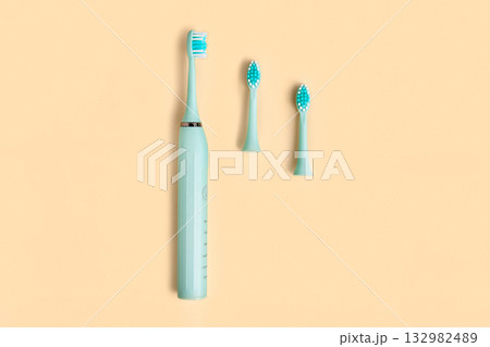 Electric Toothbrush. Top View, Flat Lay, Copy Space. Dental Care Supplies on Beige Pastel Studio Background. Oral Hygiene, Gum Health, Healthy Teeth. Modern Dental Ultrasonic Vibration Tooth Brush Set Electric Toothbrush. Top View, Flat Lay, Copy Space. Dental Care Supplies on Beige Pastel Studio Background. Oral Hygiene, Gum Health, Healthy Teeth. Modern Dental Ultrasonic Vibration Tooth Brush Set 132982489