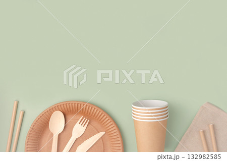 Eco - Friendly Tableware on Green Background. Top View. Plastic free Set of Brown Paper Utensil. Street Food Recyclable Packaging. Zero waste Paperware. Mockup. Disposable Take out Cup, wooden cutlery Eco - Friendly Tableware on Green Background. Top View. Plastic free Set of Brown Paper Utensil. Street Food Recyclable Packaging. Zero waste Paperware. Mockup. Disposable Take out Cup, wooden cutlery 132982585