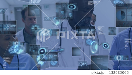 Analyzing diverse medical team reviewing holographic data in corridor, with stethoscope and tablet 132983066