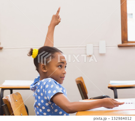 African American child student raising finger at open notebook on desk in classroom, copy space 132984012