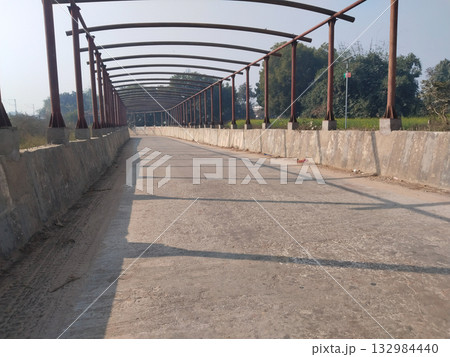 Under-construction road underpass with visible iron roof frame awaiting plastic sheet covering, captured during urban development in India 132984440