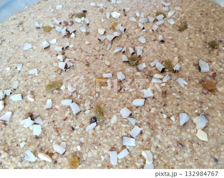 Traditional Indian peanut halwa spread on metal plate for cooling, rich dessert made with mungfali, sugar, and ghee, popular sweet during festivals and special rural occasions Traditional Indian peanut halwa spread on metal plate for cooling, rich dessert made with mungfali, sugar, and ghee, popular sweet during festivals and special rural occasions 132984767