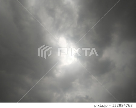Dark rain clouds gathering in the sky with dramatic overcast atmosphere, no rainfall yet, representing monsoon season buildup and pre-rain weather conditions. 132984768