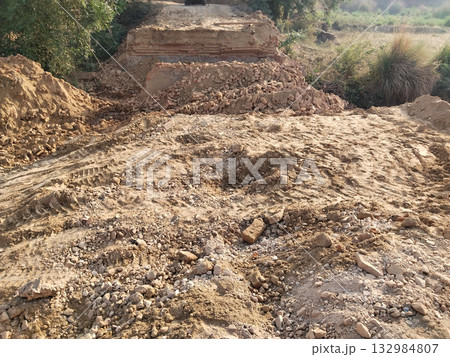 Demolished Old Bridge with Scattered Bricks and Earth Preparing for New Construction Reflecting Rural Development and Modern Engineering Under Open Sky with Vegetation and Future Infrastructure Plans Demolished Old Bridge with Scattered Bricks and Earth Preparing for New Construction Reflecting Rural Development and Modern Engineering Under Open Sky with Vegetation and Future Infrastructure Plans 132984807