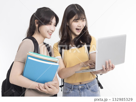 Excited Asian female students watching the laptop Excited Asian female students watching the laptop 132985329