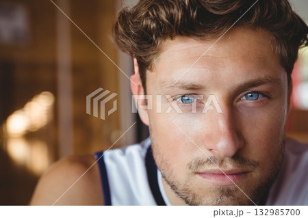 Adult male leaning at camera in corridor wearing white sleeveless shirt with dark trim, copy space Adult male leaning at camera in corridor wearing white sleeveless shirt with dark trim, copy space 132985700