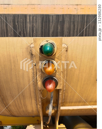 Close-up of triple indicator lights on fuel tanker discharge valve showing red, yellow, green safety signals for diesel or petrol unloading, industrial fuel transport, India Close-up of triple indicator lights on fuel tanker discharge valve showing red, yellow, green safety signals for diesel or petrol unloading, industrial fuel transport, India 132986280